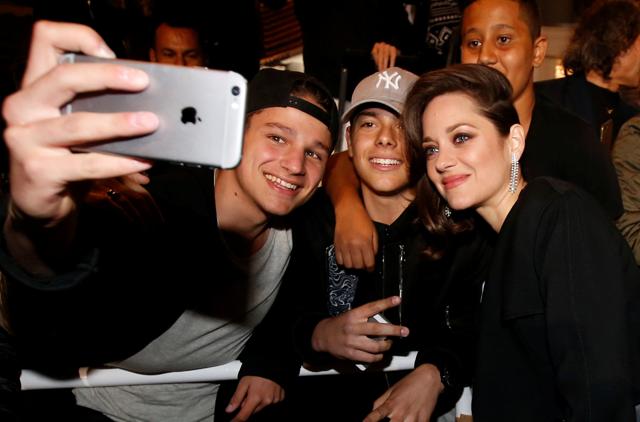 Cast member Marion Cotillard (R) takes a selfie with cinema fans after the screening of the film Juste la fin du monde (It's Only the End of the World). (REUTERS)