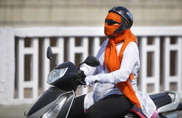 Woman holding umbrellas to protect themselves from the heat. (PTI) Woman holding umbrellas to protect themselves from the heat. (PTI)