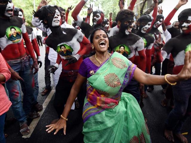 AIADMK supporters celebrate after winning the Tamil Nadu election outside their party office in Chennai.(AP)