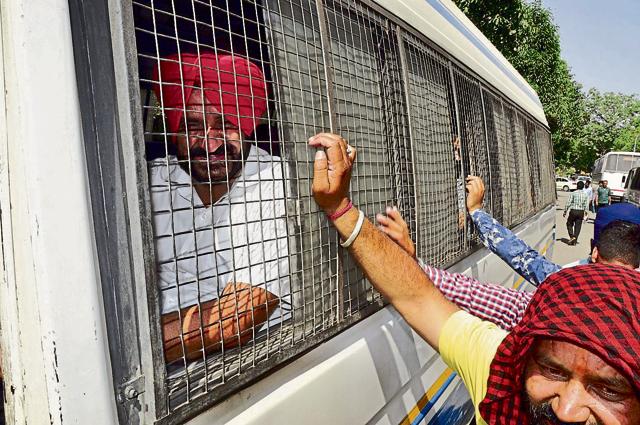Akali councillor Kanwaljit Singh Karwal being taken away from Guru Harkrishan Public School in a police vehicle.(Sikander Singh Chopra/HT Photo)