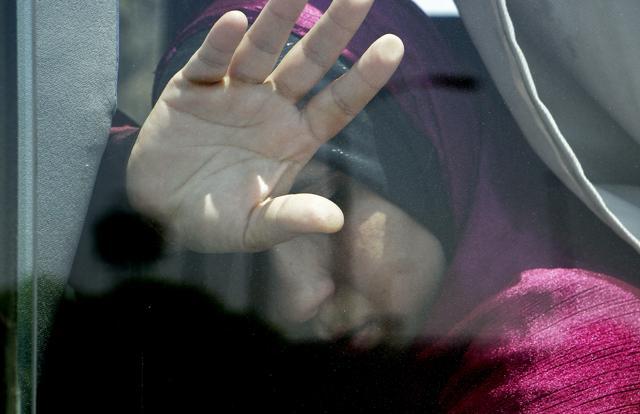 A relative of a passenger on an EgyptAir flight that crashed early Thursday puts her hand on the window from inside a bus at Cairo International Airport. (AP) A relative of a passenger on an EgyptAir flight that crashed early Thursday puts her hand on the window from inside a bus at Cairo International Airport. (AP)