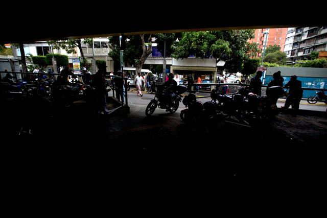 In this April 7, 2016 photo, moto-taxi drivers wait for clients at their station near the site where Roberto Bernal was beaten and burned alive. (AP) In this April 7, 2016 photo, moto-taxi drivers wait for clients at their station near the site where Roberto Bernal was beaten and burned alive. (AP)