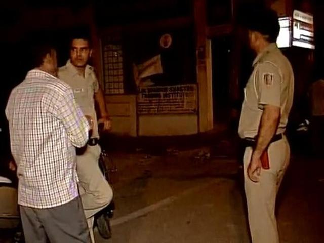 Police officers investigate the murder of a 23-year-old African national in Vasant Kunj.(ANI Photo)