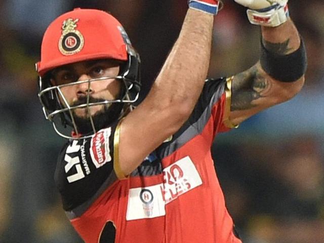Royal Challengers Bangalore captain and batsman Virat Kohli (L) raises his bat after scoring his half century. (PTI Photo) Royal Challengers Bangalore captain and batsman Virat Kohli (L) raises his bat after scoring his half century. (PTI Photo)