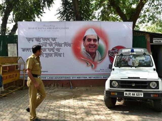 A police officer walks in front of a hoarding bearing the image of former prime minister Rajiv Gandhi outside the All India Congress Committee office in New Delhi. (AFP) A police officer walks in front of a hoarding bearing the image of former prime minister Rajiv Gandhi outside the All India Congress Committee office in New Delhi. (AFP)