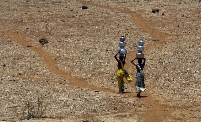 Women walk home after collecting drinking water from a well at Mengal Pada in Thane district in Maharashtra. (AP file photo) Women walk home after collecting drinking water from a well at Mengal Pada in Thane district in Maharashtra. (AP file photo)
