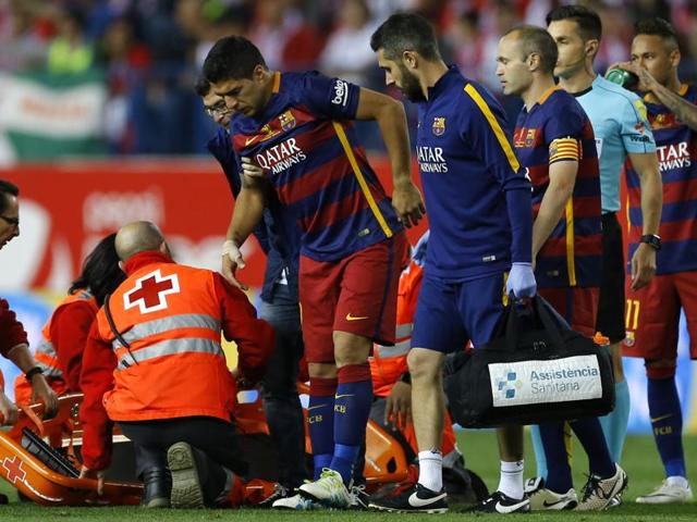 Barcelona's Luis Suarez looks dejected as he goes off injured against Sevilla.(Reuters Photo)