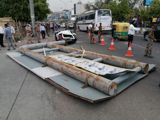 A giant signboard fell during a storm on a car and a bike passing by outside DLF mall, Sector 18, Noida on Monday. (Burhaan Kinu / HT Photo) A giant signboard fell during a storm on a car and a bike passing by outside DLF mall, Sector 18, Noida on Monday. (Burhaan Kinu / HT Photo)