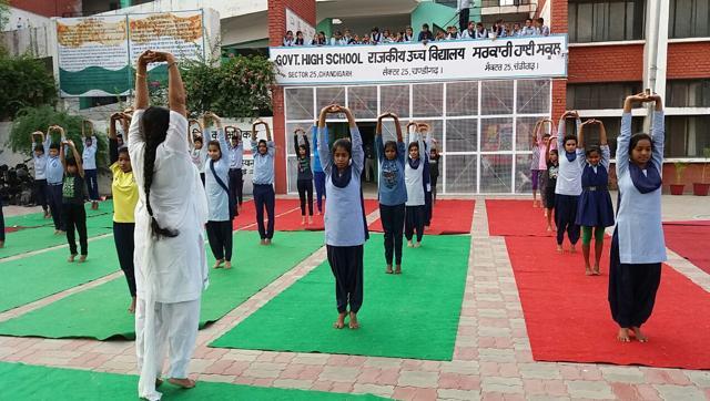 Students practising yoga at a camp in Government High School, Sector 25, on Monday. (HT Photo)