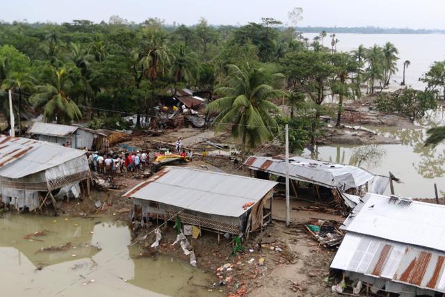 Bangladeshi villagers inspect destroyed homes in Chittagong on Sunday after Cyclone Roanu struck the country’s southern coastline. (AFP) Bangladeshi villagers inspect destroyed homes in Chittagong on Sunday after Cyclone Roanu struck the country’s southern coastline. (AFP)