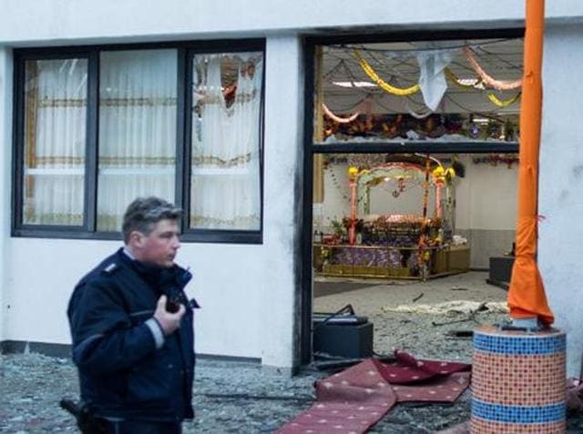 A police officer walks in front of the Sikh temple in Essen, western German where an explosion took place at a wedding on April 16, 2016. (AFP) A police officer walks in front of the Sikh temple in Essen, western German where an explosion took place at a wedding on April 16, 2016. (AFP)