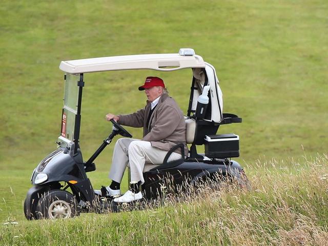In this July 31, 2015 file photo, Republican presidential candidate Donald Trump drives his golf buggy during the second day of the Women's British Open golf championship on the Turnberry golf course in Turnberry, Scotland. (AP) In this July 31, 2015 file photo, Republican presidential candidate Donald Trump drives his golf buggy during the second day of the Women's British Open golf championship on the Turnberry golf course in Turnberry, Scotland. (AP)