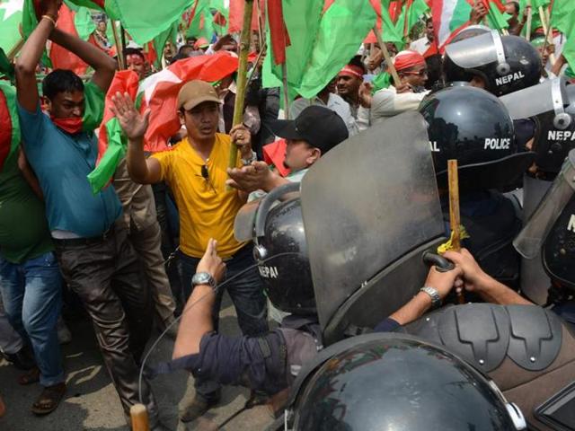 Ethnic Madhesi protesters throw stones and bricks at Nepalese policemen on November 2, 2015. (AP File) Ethnic Madhesi protesters throw stones and bricks at Nepalese policemen on November 2, 2015. (AP File)