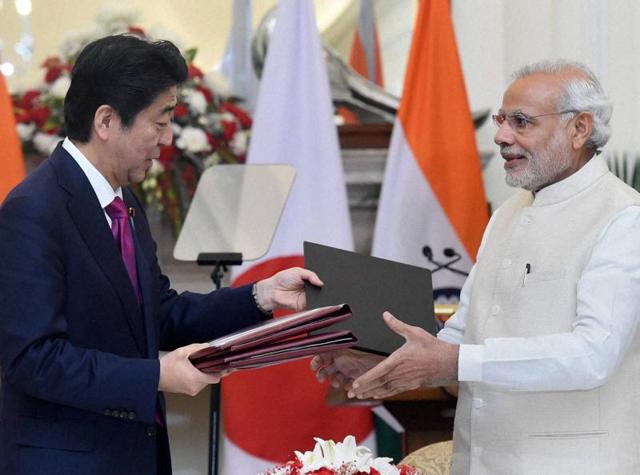 In this file photo, Prime Minister Narendra Modi and his Japanese counterpart, Shinzo Abe, can be seen exchanging documents after signing an agreement at Hyderabad House in New Delhi .(PTI)
