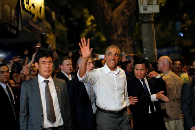 Obama waves as he leaves after having a dinner at a restaurant in Hanoi. (REUTERS) Obama waves as he leaves after having a dinner at a restaurant in Hanoi. (REUTERS)