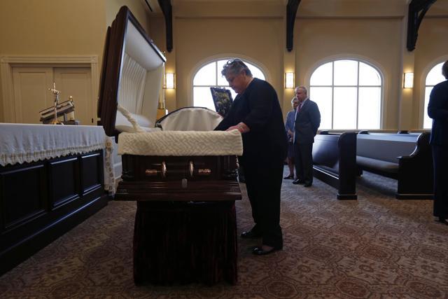 Family member Sue duTreil, pays her respects at the casket containing remains of Army Pvt. Earl Joseph Keating after it arrived at the Schoen Funeral Home in New Orleans, Monday, May 23, 2016. (AP) Family member Sue duTreil, pays her respects at the casket containing remains of Army Pvt. Earl Joseph Keating after it arrived at the Schoen Funeral Home in New Orleans, Monday, May 23, 2016. (AP)