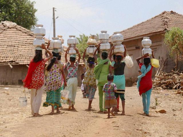 A girl carries drinking water in a plastic container on her head as she walk back to her village after collecting it from an almost dried up well in Samba district, 40 kilometres from Jammu. (AP Photo) A girl carries drinking water in a plastic container on her head as she walk back to her village after collecting it from an almost dried up well in Samba district, 40 kilometres from Jammu. (AP Photo)