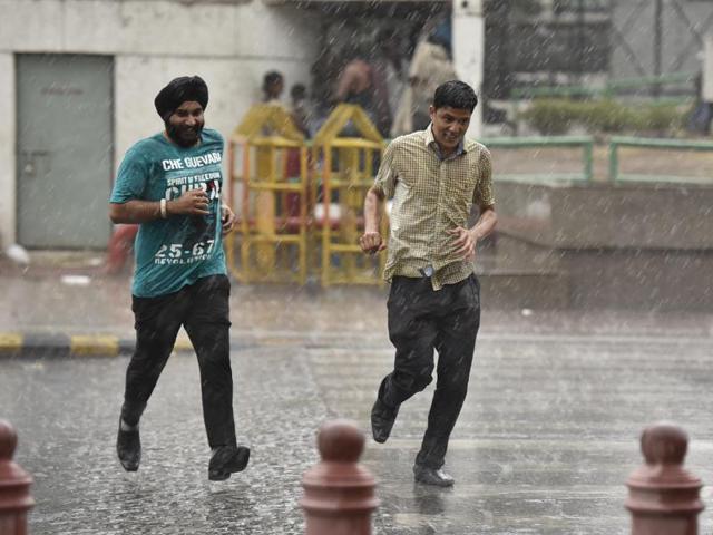 People enjoyed getting drenched in the rains, at Connaught Place in New Delhi. (Virendra Singh Gosain/ HT Photo)
