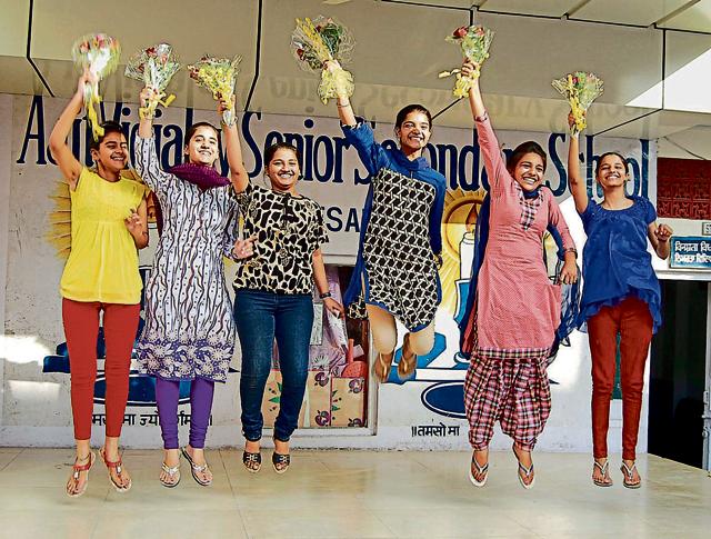 Meritorious students of Ajit Vidyalaya Senior Secondary School celebrating their success in Amritsar on Tuesday.(Sameer Sehgal/HT)