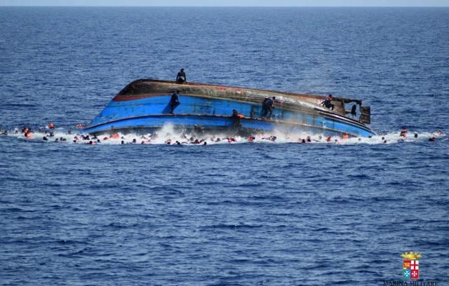 People jump out of a boat right after it overturned off the Libyan coast on Wednesday. (AP Photo) People jump out of a boat right after it overturned off the Libyan coast on Wednesday. (AP Photo)