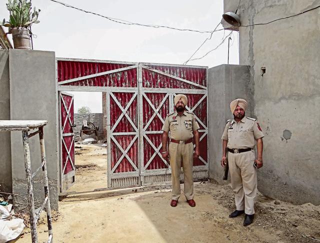 Cops deployed outside the house from where gangsters fled in a police vehicle at Butter Kalan village in Moga on Tuesday. (HT Photo) Cops deployed outside the house from where gangsters fled in a police vehicle at Butter Kalan village in Moga on Tuesday. (HT Photo)