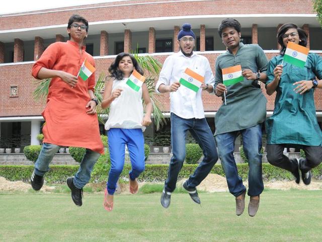 Students hold the national flag at Shri Ram College of Commerce in Delhi University, Delhi. (S.Burmaula \ HT file)