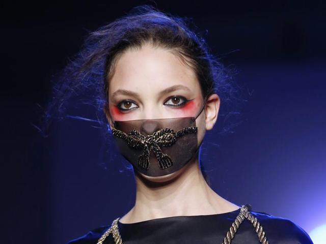 Red was dotted around the outer corners of the models’ eyes and combined with a scarlet lip or a mask at Olympia Le Tan - Paris Fashion Week spring-summer 2016. (AFP) 