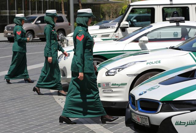 In this Thursday May 19, 2016 photo, Dubai police women walk towards their luxury cars during a demonstration in Dubai, United Arab Emirates. (AP) In this Thursday May 19, 2016 photo, Dubai police women walk towards their luxury cars during a demonstration in Dubai, United Arab Emirates. (AP)