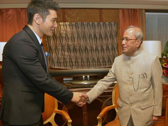 President Pranab Mukherjee shakes hands with Chinese film actor Huang Xiaoming at a meeting in Beijing, China. (PTI) President Pranab Mukherjee shakes hands with Chinese film actor Huang Xiaoming at a meeting in Beijing, China. (PTI)