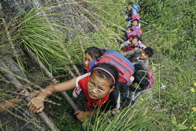The ladder is the only access to the village of Atuleer to which the children return every two weeks from the school at which they board (AP) The ladder is the only access to the village of Atuleer to which the children return every two weeks from the school at which they board (AP)