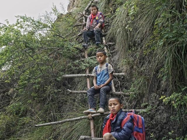 In this May 14, 2016 photo, children carrying their schoolbags take rest on the ladder built on a cliff in Zhaojue county, southwest China's Sichuan province. (AP) In this May 14, 2016 photo, children carrying their schoolbags take rest on the ladder built on a cliff in Zhaojue county, southwest China's Sichuan province. (AP)
