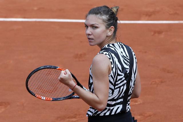 Romania's Simona Halep clenches her fist after winning her third round match of the French Open tennis tournament against Japan’s Naomi Osaka at the Roland Garros stadium. (AP Photo) Romania's Simona Halep clenches her fist after winning her third round match of the French Open tennis tournament against Japan’s Naomi Osaka at the Roland Garros stadium. (AP Photo)