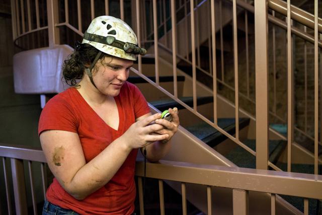 Abby Harmon, 27, of Knoxville, Tenn., checks her phone after being rescued from Hidden River Cave on Thursday. (AP) Abby Harmon, 27, of Knoxville, Tenn., checks her phone after being rescued from Hidden River Cave on Thursday. (AP)