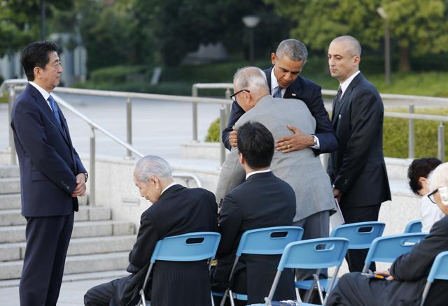 US Presdent Barack Obama (2nd R) comforts A-bomb survivor Shigeaki Mori (C) as Japanese Prime Minister Shinzo Abe (L) looks on after laying a wreath in front of the cenotaph to offer a prayer for victims of the atomic bombing in 1945 at the Hiroshima Peace Memorial Park in Hiroshim. (AFP) US Presdent Barack Obama (2nd R) comforts A-bomb survivor Shigeaki Mori (C) as Japanese Prime Minister Shinzo Abe (L) looks on after laying a wreath in front of the cenotaph to offer a prayer for victims of the atomic bombing in 1945 at the Hiroshima Peace Memorial Park in Hiroshim. (AFP)