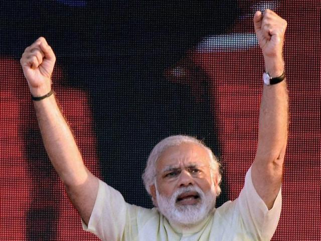 Bharatiiya Janata Party workers garlanding Prime Minister Narendra Modi at a rally to mark the second anniversary of the formation of his government at the centre, in Saharanpur, India, on Thursday, May 26, 2016(ASHOK DUTTA)