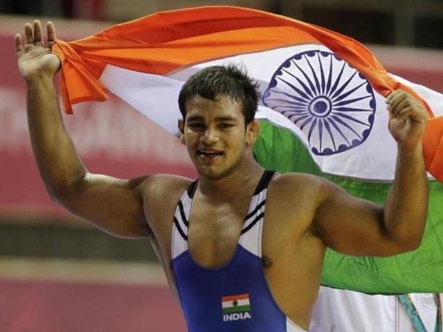 Narsingh Pancham Yadav holds his national flag as he celebrates winning the gold medal.(Reuters Photo)