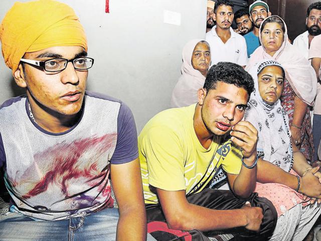 Mandeep Singh (in yellow T-shirt), who was with victim Ajmer Singh in the car at the time of encounter, at Jeeda village in Bathinda district on Thursday.(Sanjeev Kumar/HT Photo)