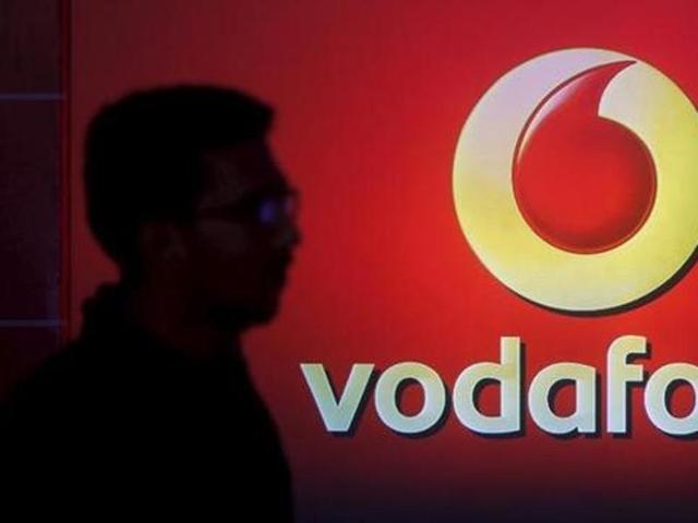 A man casts a silhouette onto an electronic screen displaying a Vodafone logo, in Mumbai. (Reuters) A man casts a silhouette onto an electronic screen displaying a Vodafone logo, in Mumbai. (Reuters)