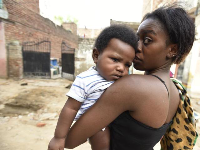 Kate Igbonosa, 26, with her child at at Rajpur Khurd village in Delhi. Kate’s husband, Kenneth, was beaten up by locals when they were returning home.(Virendra Singh Gosain/ Hindustan Times)