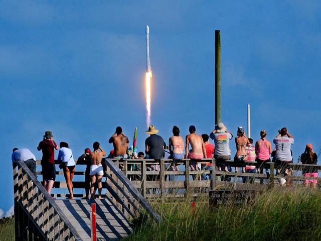 Crowds pack the Canaveral National Seashore Friday, to witness the liftoff of a SpaceX Falcon 9 rocket with the THAICOM-8 satellite aboard, from Launch Complex 40 at the Cape Canaveral Air Force Station. (Craig Rubadoux/Florida Today via AP) Crowds pack the Canaveral National Seashore Friday, to witness the liftoff of a SpaceX Falcon 9 rocket with the THAICOM-8 satellite aboard, from Launch Complex 40 at the Cape Canaveral Air Force Station. (Craig Rubadoux/Florida Today via AP)