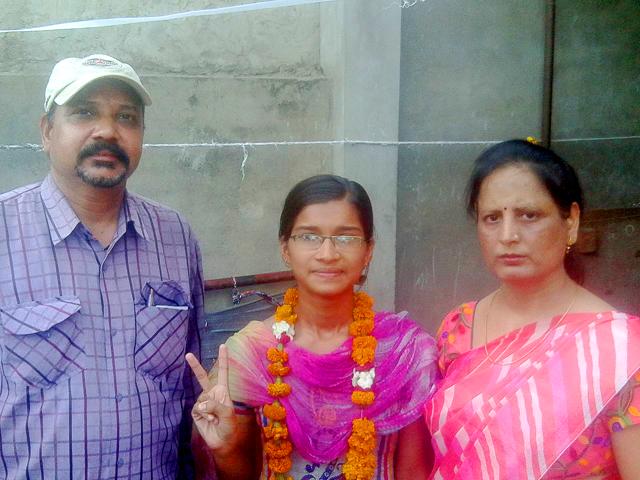 Life changed overnight for Shivani Prajapat, 17, daughter of a rickshaw-puller, who clinched the sixth place on the state’s merit list of Class 12 (Arts) exam. Shivani (centre) with principal of her school Satish Singh and vice principal Sunita Bedi. (Handout image) Life changed overnight for Shivani Prajapat, 17, daughter of a rickshaw-puller, who clinched the sixth place on the state’s merit list of Class 12 (Arts) exam. Shivani (centre) with principal of her school Satish Singh and vice principal Sunita Bedi. (Handout image)