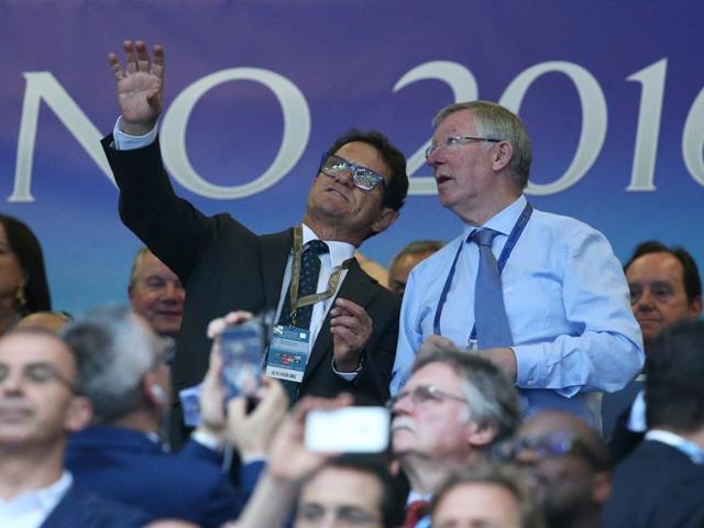 Fabio Capello and former Manchester United manager Sir Alex Ferguson sit in the stands. (Reuters Photo)