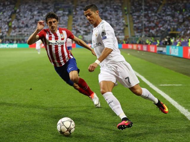 Real Madrid's Cristiano Ronaldo in action with Atletico Madrid's Stefan Savic in the first half of the Uefa Champions League final. (Reuters Photo)