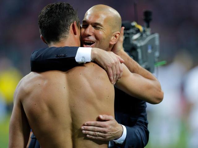 Real Madrid's Cristiano Ronaldo is embraced by Real Madrid's head coach Zinedine Zidane after scoring the winning penalty shot during the Champions League final football match. (AP Photo) Real Madrid's Cristiano Ronaldo is embraced by Real Madrid's head coach Zinedine Zidane after scoring the winning penalty shot during the Champions League final football match. (AP Photo)