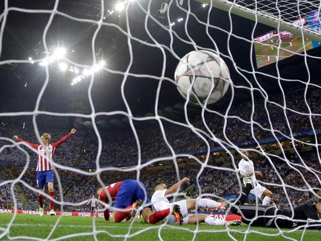 Atletico's Yannick Carrasco scores his side's first goal during the Champions League final football match between Real Madrid and Atletico Madrid at the San Siro stadium in Milan, Italy. (AP Photo) Atletico's Yannick Carrasco scores his side's first goal during the Champions League final football match between Real Madrid and Atletico Madrid at the San Siro stadium in Milan, Italy. (AP Photo)