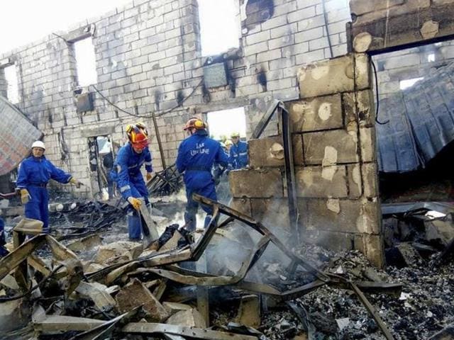 Rescuers inspect the debris of a residential house after a fire broke out, in the village of Litochky, northeast of Kiev, Ukraine, May 29, 2016. (Reuters) Rescuers inspect the debris of a residential house after a fire broke out, in the village of Litochky, northeast of Kiev, Ukraine, May 29, 2016. (Reuters)