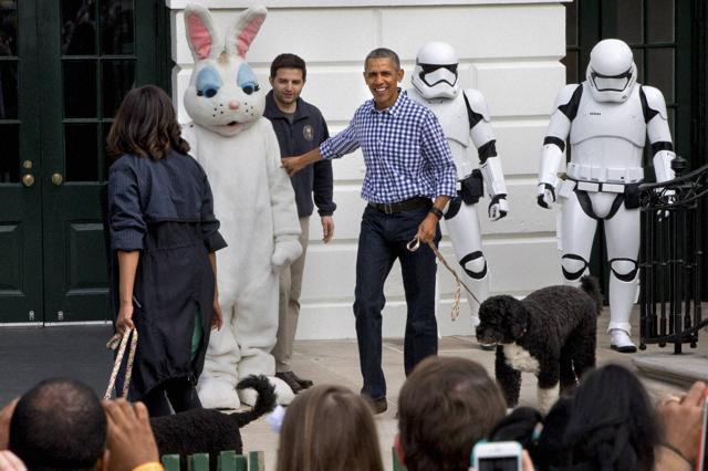 US President Barack Obama and First Lady Michelle Obama, with the Easter Bunny and their two dogs, Sunny, and Bo (right) walk past costumed Star Wars Storm Troopers during the White House Easter Egg Roll at the White House in Washington. (AP Photo) US President Barack Obama and First Lady Michelle Obama, with the Easter Bunny and their two dogs, Sunny, and Bo (right) walk past costumed Star Wars Storm Troopers during the White House Easter Egg Roll at the White House in Washington. (AP Photo)