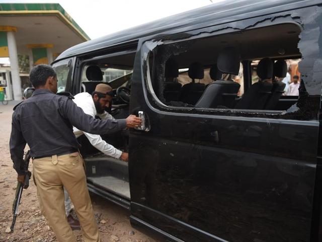 Pakistani security officials examine a vehicle attacked in Karachi on Monday. (AP Photo) Pakistani security officials examine a vehicle attacked in Karachi on Monday. (AP Photo)
