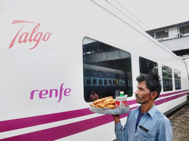 A vendor walks near the Spanish train Talgo after it arrives at Moradabad railway station during its first trial run between Bareilly and Moradabad on Sunday. (PTI Photo) A vendor walks near the Spanish train Talgo after it arrives at Moradabad railway station during its first trial run between Bareilly and Moradabad on Sunday. (PTI Photo)