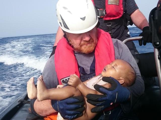 A Sea-Watch humanitarian organisation crew member holds a drowned migrant baby, during a rescue operation off the coasts of Libya. (AP Photo) A Sea-Watch humanitarian organisation crew member holds a drowned migrant baby, during a rescue operation off the coasts of Libya. (AP Photo)